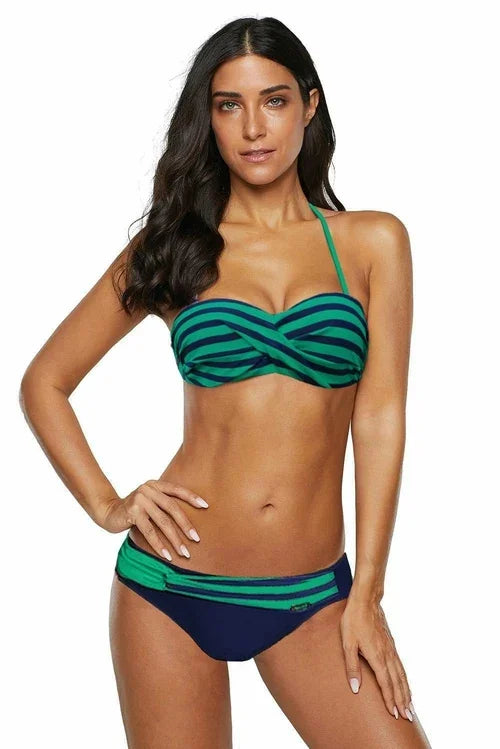 Woman wearing a green and navy blue striped bikini set.