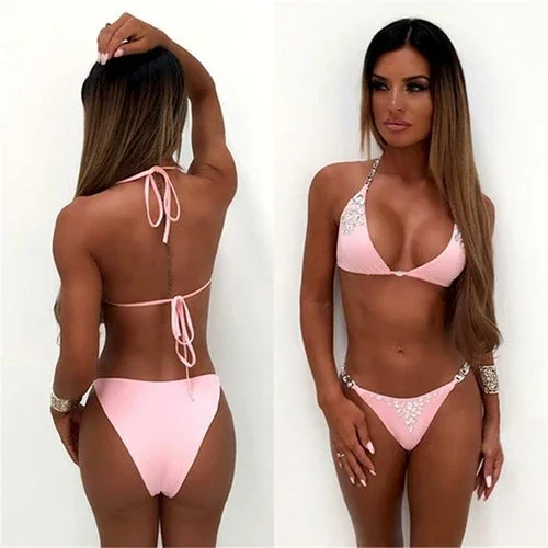 Woman wearing a light pink triangle bikini set with rhinestone detailing.
