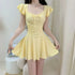 Woman wearing a pale yellow ruffle sleeve one-piece swimsuit with a bow detail.