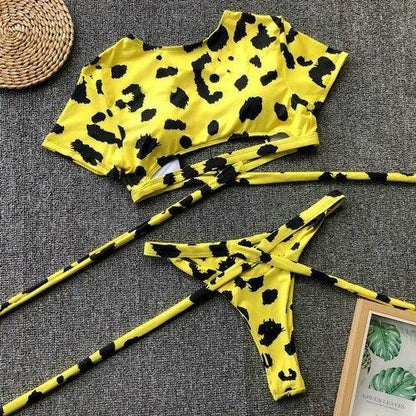 Yellow and black leopard print bikini set with a cropped top and tie-side bottoms.