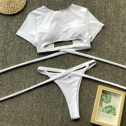White two-piece bikini set featuring a short sleeve crop top and side-tie bikini bottoms.