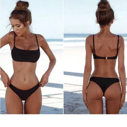 Front and back view of a woman wearing a minimalist black two-piece bikini on a beach.