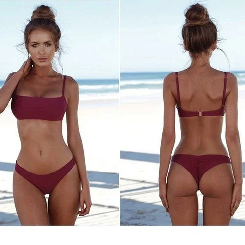 Front and back view of a woman wearing a burgundy two-piece bikini set on a sandy beach.