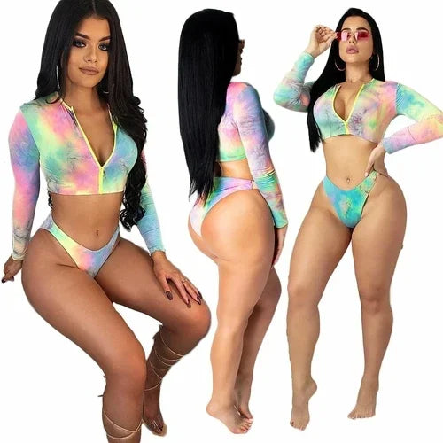 Woman wearing a tie-dye long sleeve crop top and matching bikini bottom set.