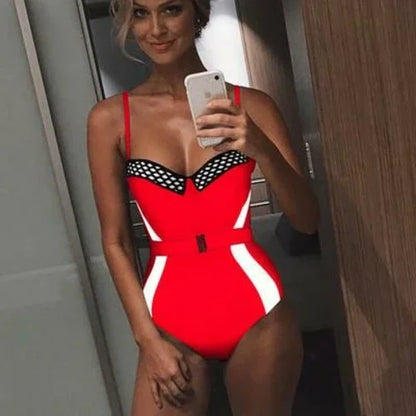 Woman in a red one-piece swimsuit with black mesh detailing and white side stripes.