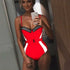 Woman in a red one-piece swimsuit with black mesh detailing and white side stripes.