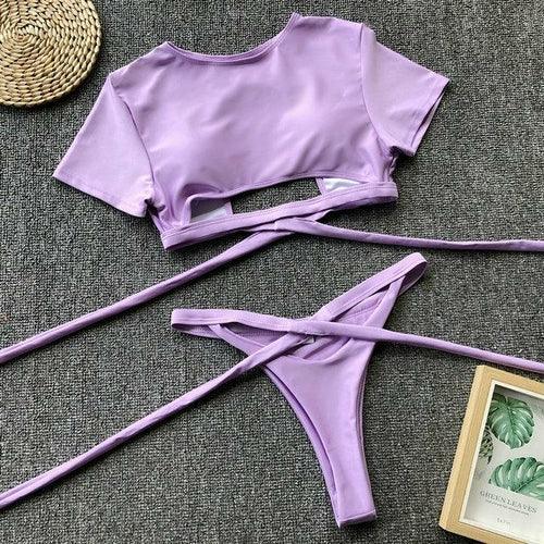Lavender purple two-piece wrap bikini set with crop top and tie-side bottoms.