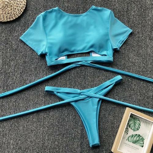 Turquoise blue two-piece bikini set with short sleeve crop top and tie-side bottoms