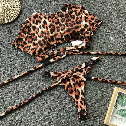 Two-piece leopard print bikini set featuring a long sleeve crop top and tie-side bottoms.